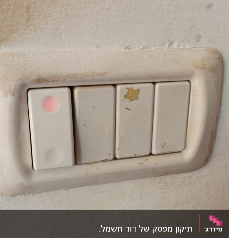 מתגי חשמל עם סימן בלאי על הקיר